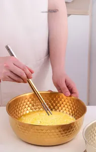 Close-up of golden hammered stainless steel salad bowl with deep anti-splash rim design