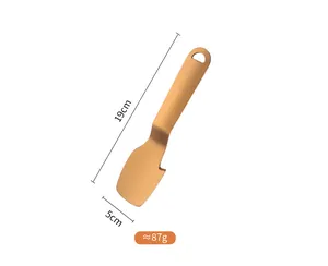 Macro view showing the 19cm dimensions and weight of the gold stainless steel peeler tool