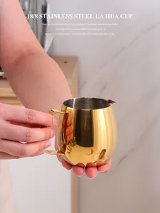 Macro detail of 18/8 stainless steel golden milk frothing pitcher with sharp spout