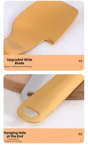 Detail view of gold stainless steel pomelo peeler with wide blade and hanging hole
