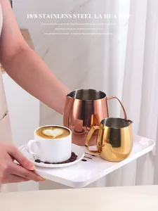 Close-up of gold and rose gold 18/8 stainless steel coffee milk frothing pitchers set