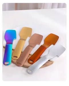 Five colorful stainless steel fruit peelers on a wooden board for modern kitchen use