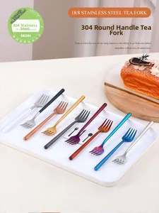 Detail of 304 stainless steel tea forks in multiple colors on a white tray