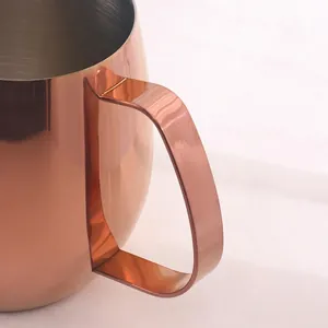 Polished rose gold stainless steel milk frothing pitcher with ergonomic flat handle
