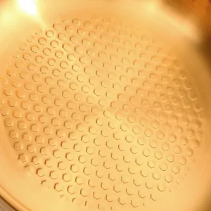 Stainless steel salad bowl with hammered texture and golden honeycomb non-stick interior