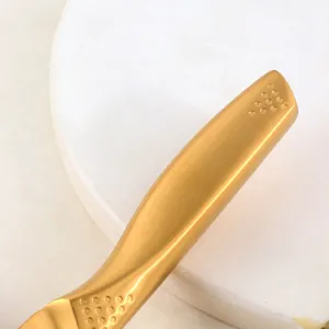 Golden stainless steel noodle cutter with matte brushed finish and non-slip handle grip