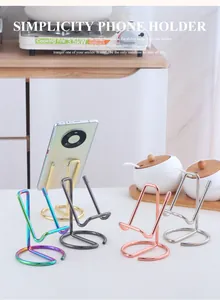 Detail shot of minimalist metal phone stands in five metallic finishes on a kitchen counter