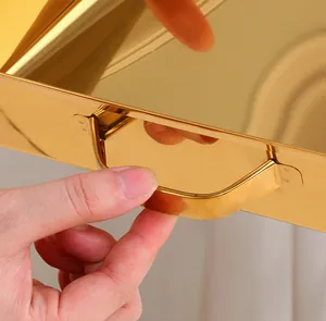 Close-up of golden stainless steel scoop with polished mirror finish and curved handle