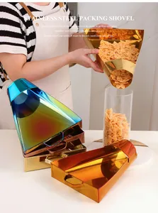 Close-up of food grade stainless steel packing shovel scooping pasta into a jar
