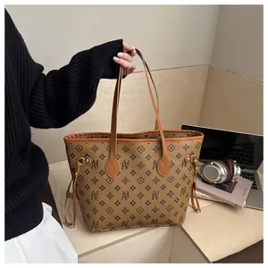 Detailed view of brown retro printed tote bag with leather texture and side drawstring