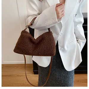 Detail of plush brown lamb wool tote bag showing soft texture and leather handle