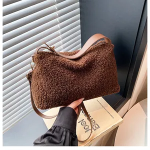 Detail of plush faux shearling small square bag in dark brown with gold metal zippers