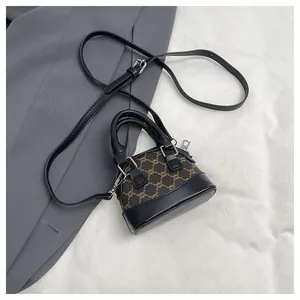 Top view of mini shell bag featuring brown monogram canvas and black leather trim