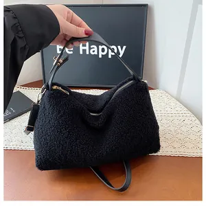 Detail of plush black faux shearling handbag with premium gold hardware and leather strap