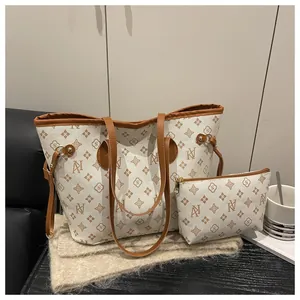 Detail of cream large tote bag with brown trim and matching small zipper pouch