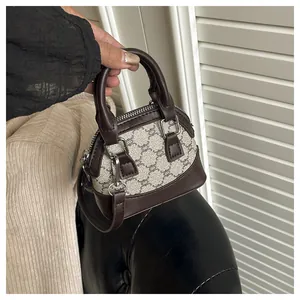 Detail of vintage patterned handbag with dual handles and metal zipper hardware