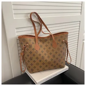 Close-up of monogram pattern and adjustable side drawstring on tote bag