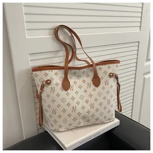 Detail of monogram jacquard tote bag with leather trim and decorative side drawstring