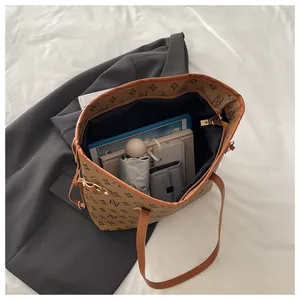 Macro view of spacious brown tote bag interior showing large capacity for essentials