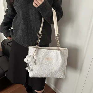 Chic cream-white textured tote bag with gold chain strap and cute cloud charm accessory