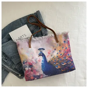 Detail of canvas tote bag featuring peacock oil painting print and frayed fringe edges