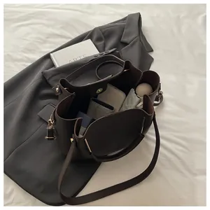 Detail view of the spacious interior of a dark brown lychee leather bucket bag