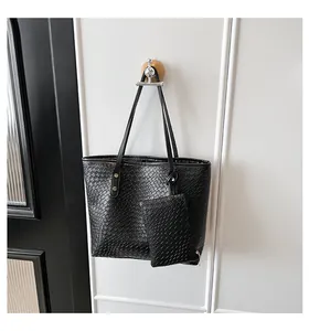 Detail of black faux leather tote with animal texture and matching zipper pouch