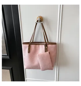 Detail of pink woven texture tote bag and matching pouch with brown shoulder straps