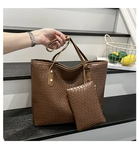 Macro view of woven textured dark brown tote bag and small matching pouch details