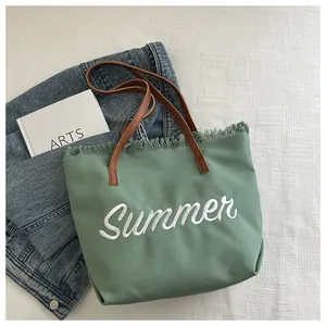Détail du cabas en toile verte avec broderie Summer et anses en cuir marron