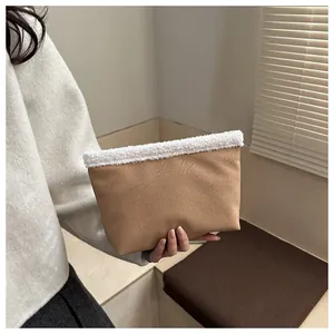 Dettaglio macro della borsa tote in pelle scamosciata marrone con bordo in sherpa bianco