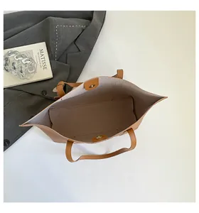 Interior view of brown leather tote bag with magnetic closure and spacious compartment