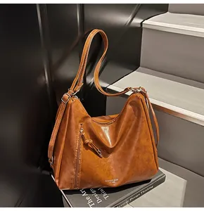 Close-up of vintage brown tote bag texture with side zipper and metal buckle details