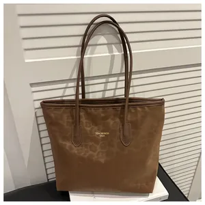Detail of leopard print tote bag with soft texture and slim shoulder handles
