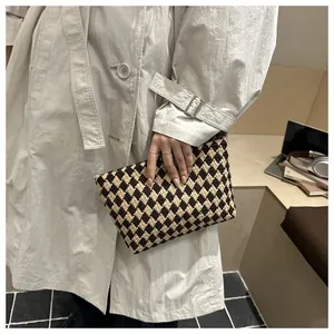 Detailed macro view of vintage brown and beige quilted woven clutch bag texture