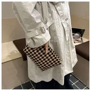 Detail showing retro harlequin check knit handbag in brown and beige texture