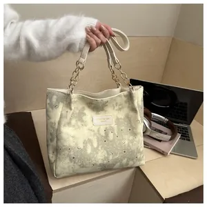 Dettaglio della borsa tote crema con motivo a stelle e logo in pelle in stile lifestyle