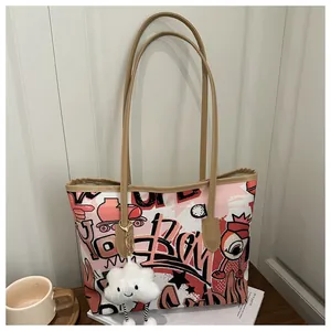 Dettaglio della borsa tote graffiti con stampe colorate e ciondolo a nuvola soffice