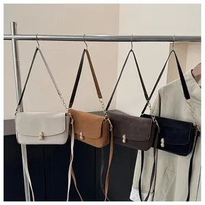Detail view of four trendy mini flap bags with unique peanut-shaped gold metal buckles