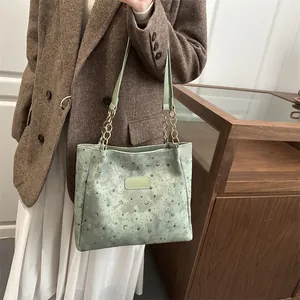 Elegante borsa tote verde menta con goffratura di stelle e luna e catena in metallo
