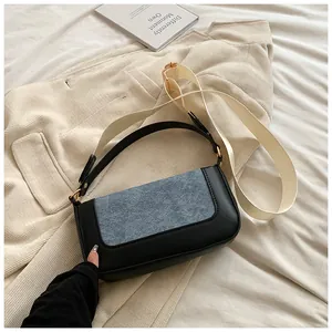 Detail of crossbody bag with blue fabric patchwork and detachable canvas strap