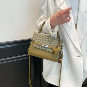 Olive green woven texture Kelly handbag with silver turn-lock and heart charm detail