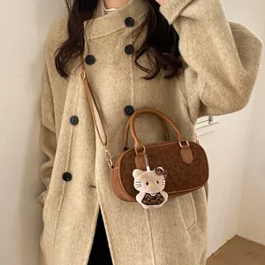 Detail of leopard print faux fur Boston bag with plush mascot on beige wool coat
