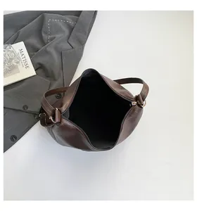 Top view of large brown faux leather tote bag with zipper and silver hardware accents
