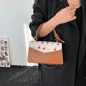 Chic brown and white crossbody bag with heart bear prints and stylish knotted handle