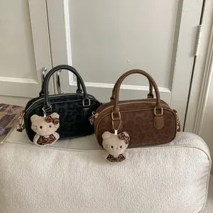 Detail of Boston bags with leopard print suede, featuring an iconic plush cat charm