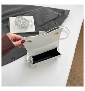 Vue détaillée de l'intérieur du sac blanc avec fermoirs magnétiques dorés et doublure