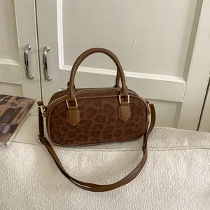 Detail of the leopard print Boston bag showing suede texture and golden metal zipper