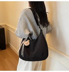 Minimalist black large capacity hobo bag with a cute brown bear plush pendant
