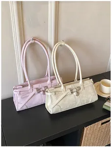 Detail of pink and cream shoulder bags featuring textured leather and belt strap buckle